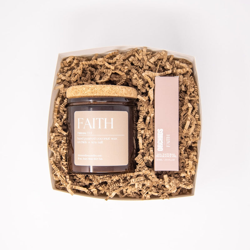 Candle in a decorative box with 'Faith' packaging on a white background