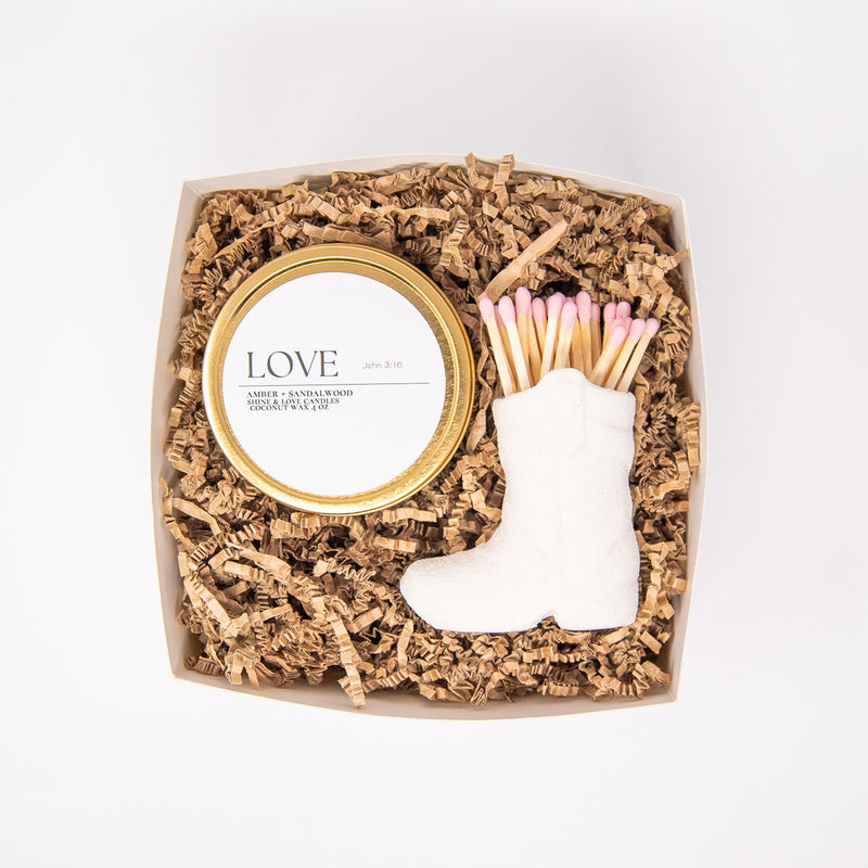 Matches in a decorative box with a boot and heart design on a white background