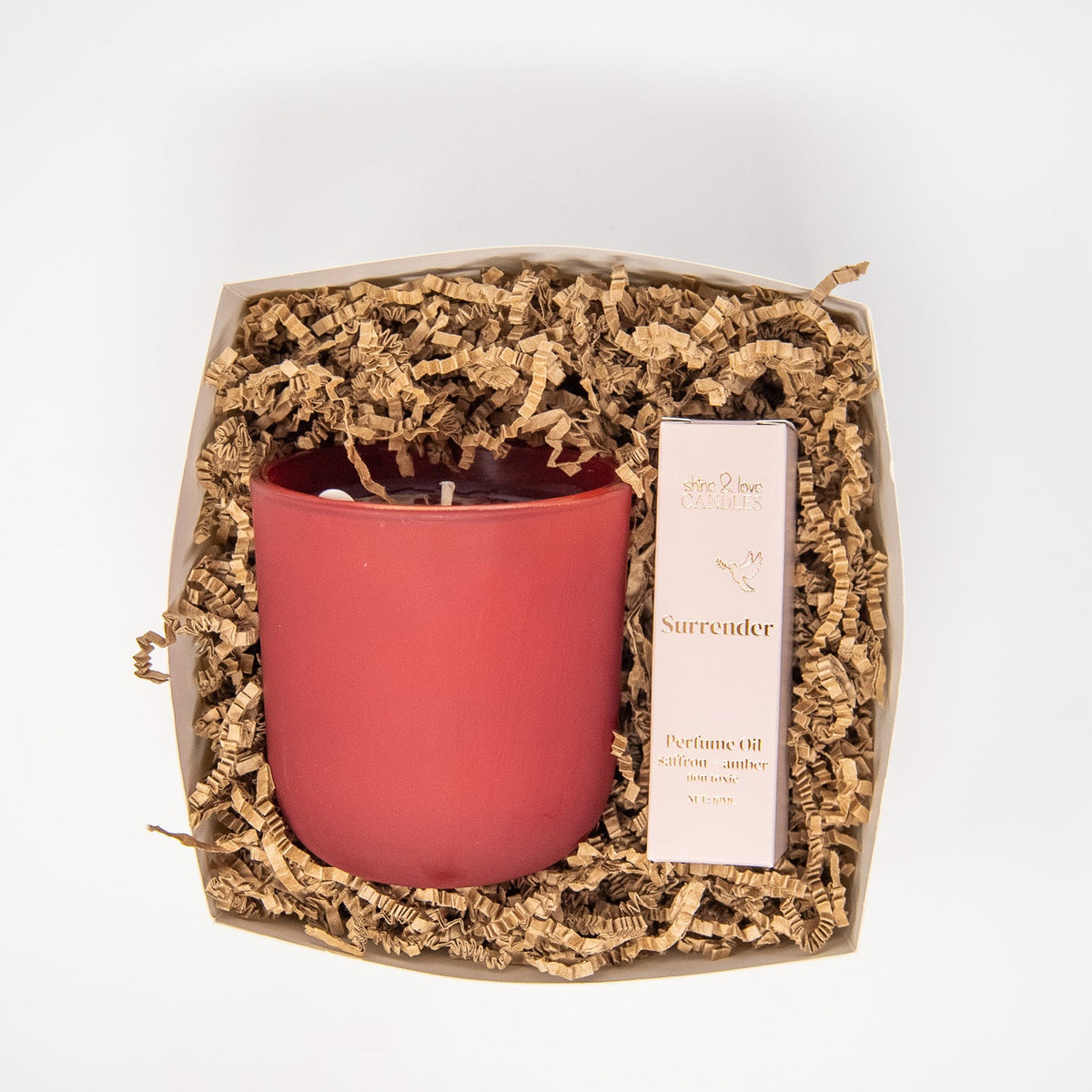 Pink candle in a decorative box with roll on perfume oil