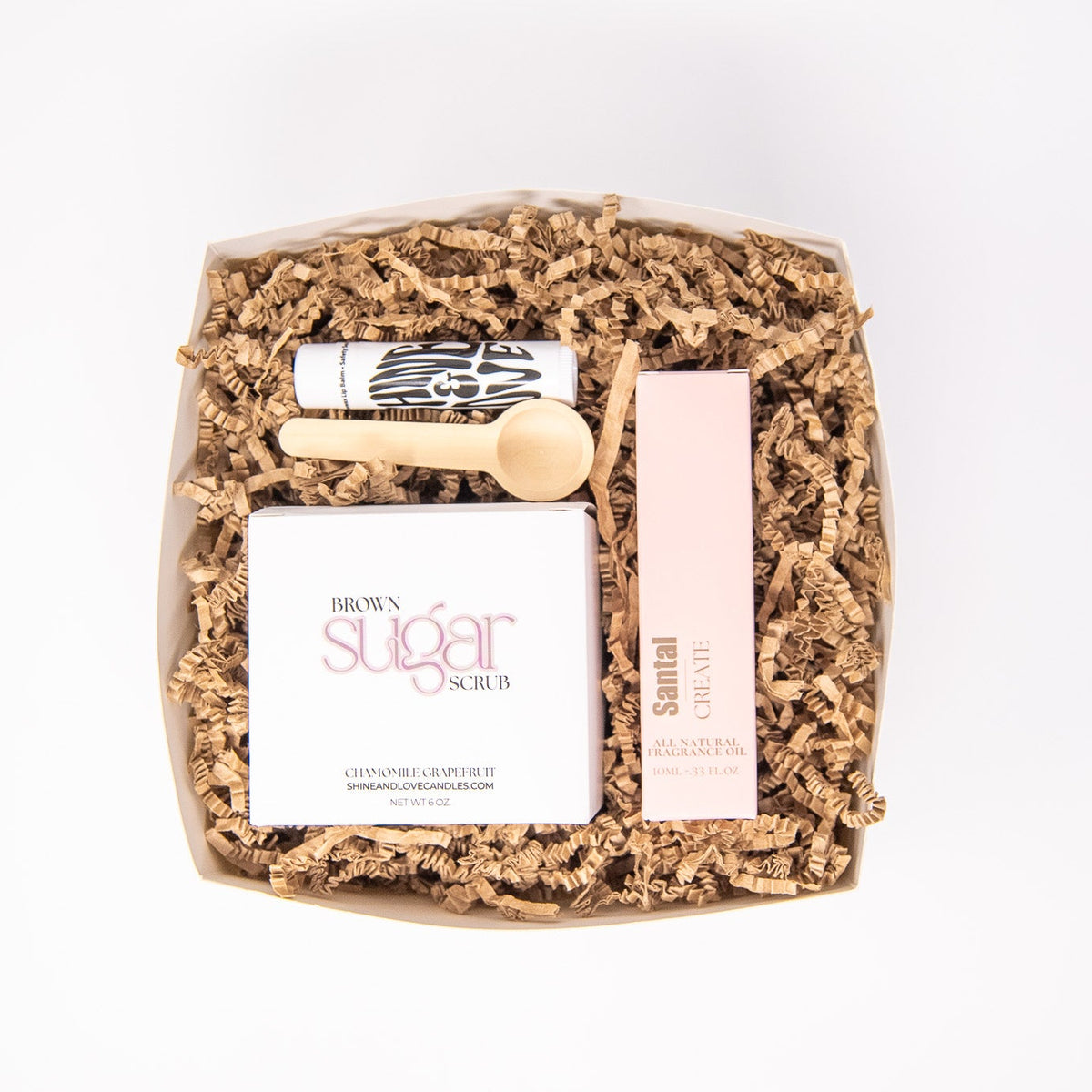 Body gift set with a sugar scrub, perfume roll on, and berry scented lip balm